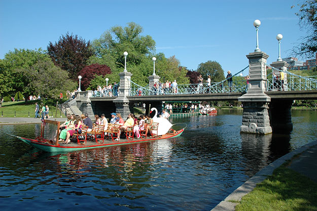 People riding swan boats at Boston Public Garden